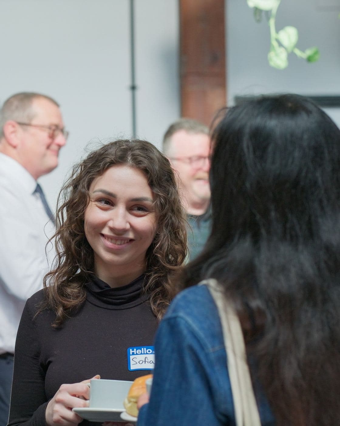 Two attendees chatting over coffee