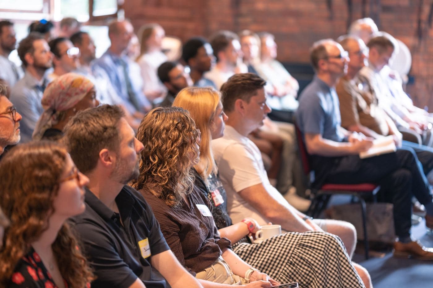 A full row of attendees listening